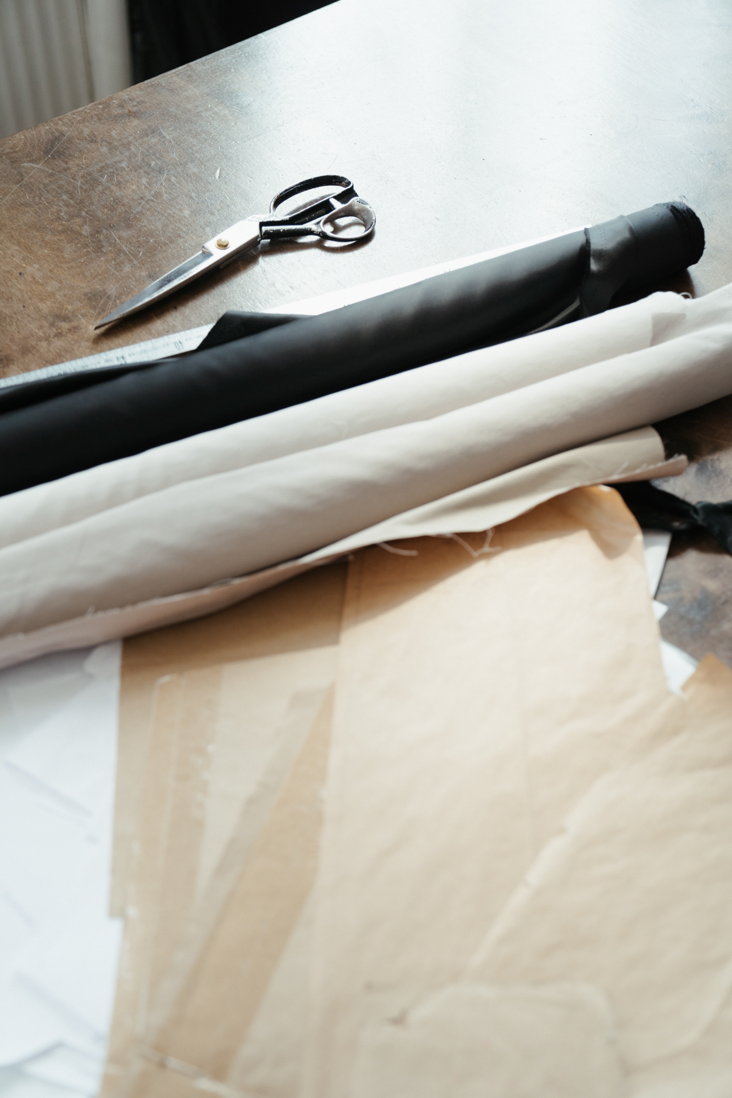 Fabrics and scissor on a table.